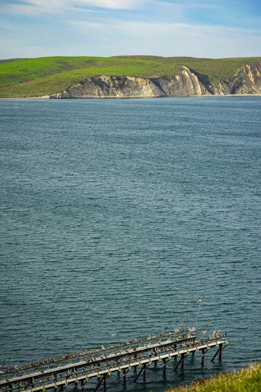 a long pier sitting on the edge of a body of water