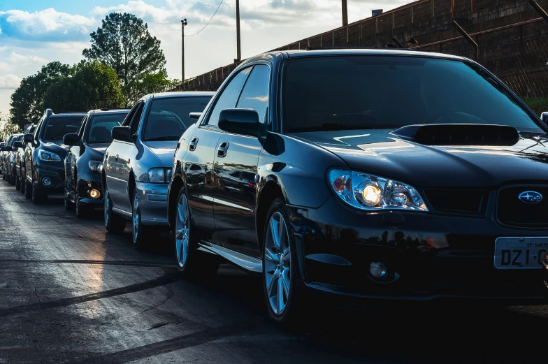 a line of cars parked along the side of a street