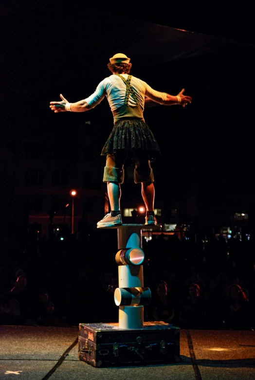 a person standing on top of a large object in the dark