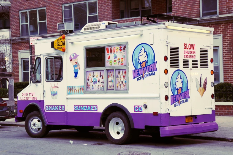 a white truck with purple trim parked on a street