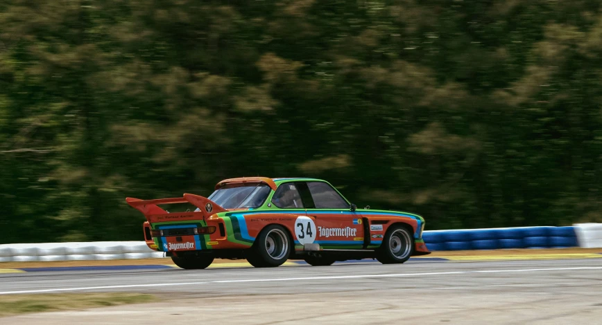 a car driving down a race track with a painted front