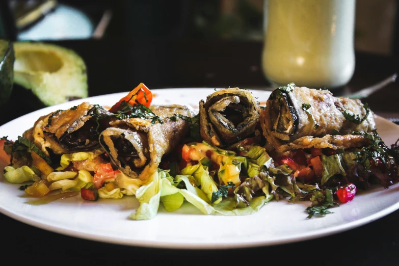 a white plate topped with food and vegetables