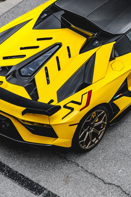 the rear end of a yellow and black race car