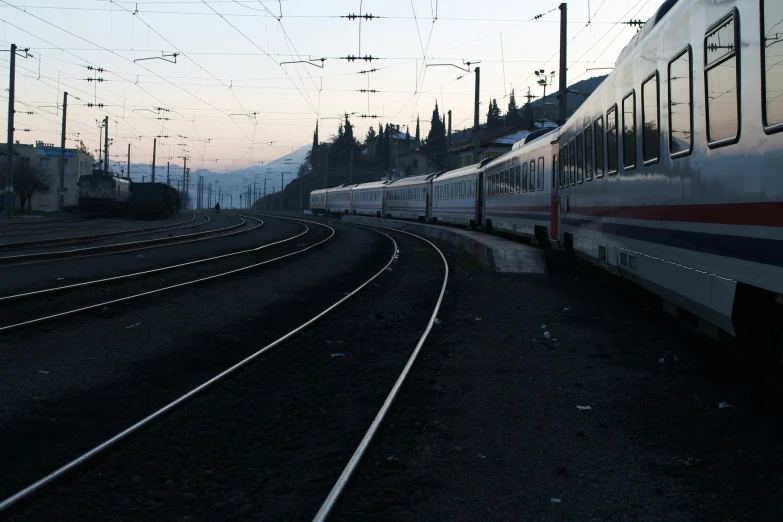 an old passenger train is stopped at the station