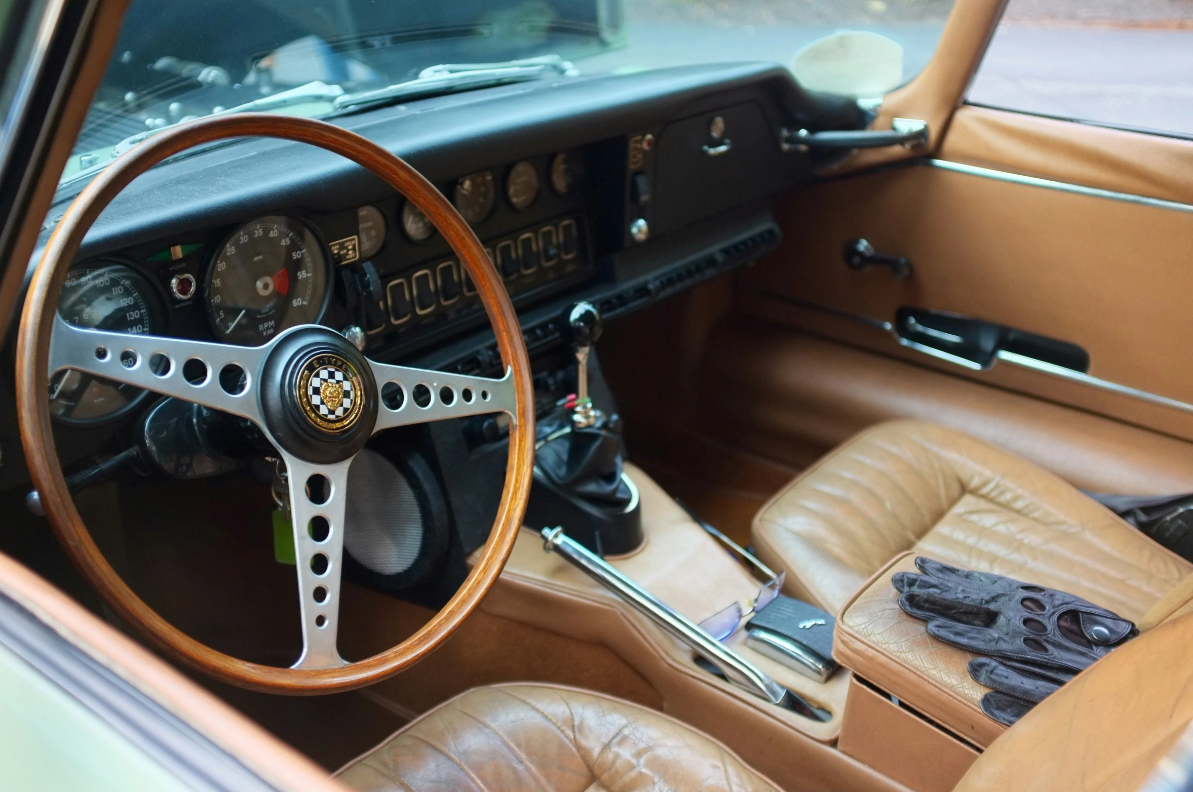 a dashboard inside a brown car with leather upholstered