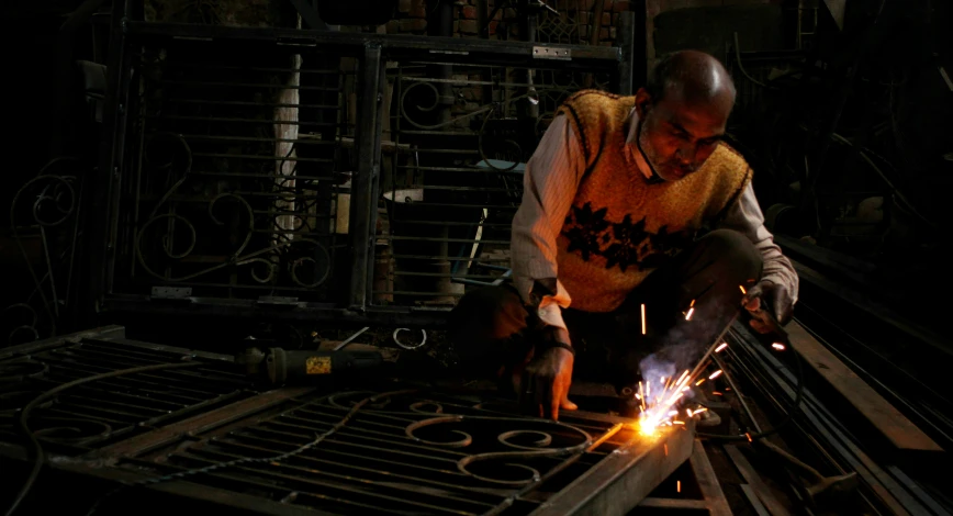 a man working on soing in a metal machine