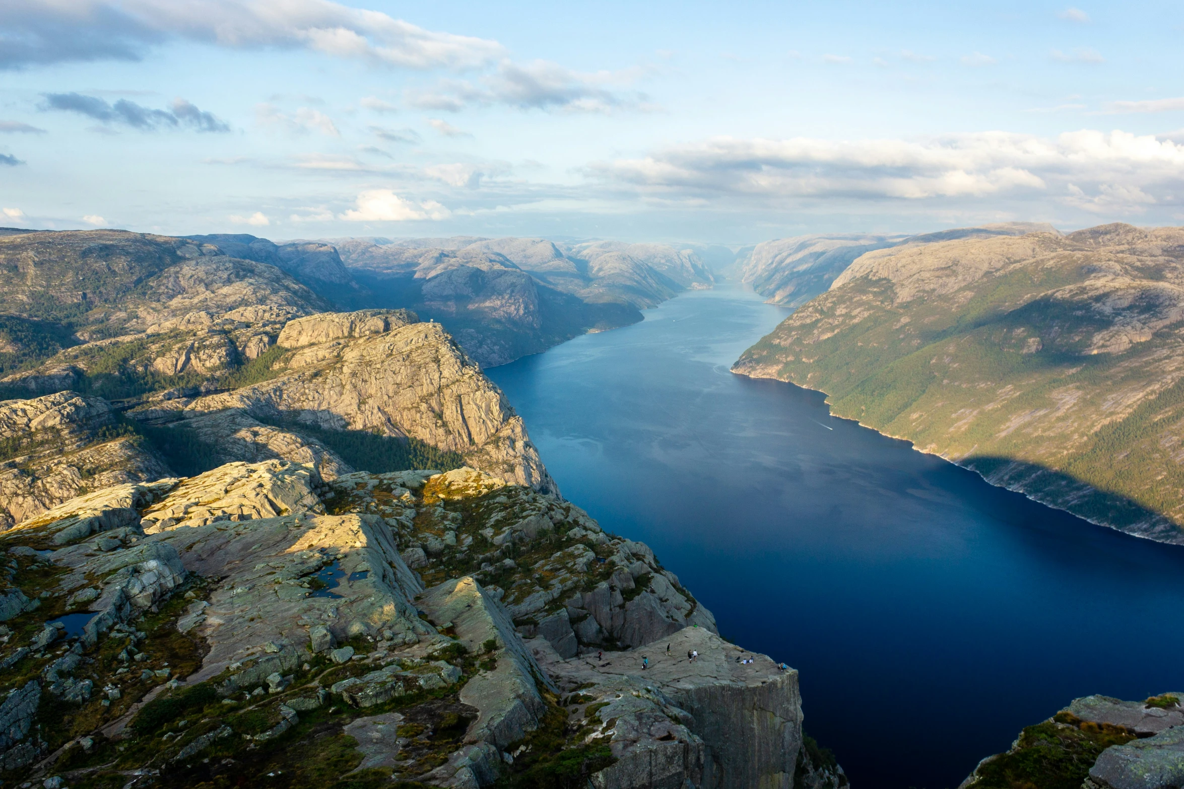 a scenic view of a valley and the water on the side