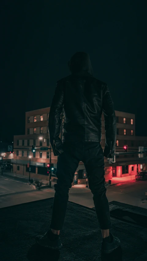 a man standing on a rooftop at night