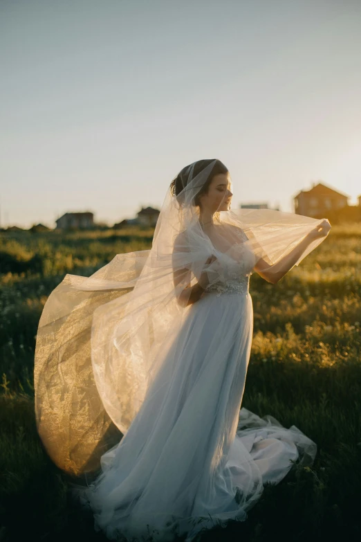 a bride in an elegant dress poses for a po