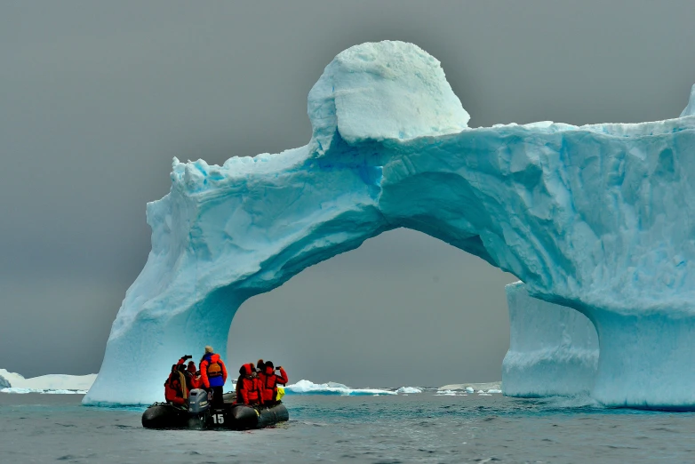 an iceberg is breaking off into the ocean
