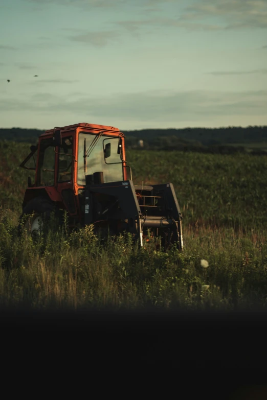 there is a tractor in the middle of the grass