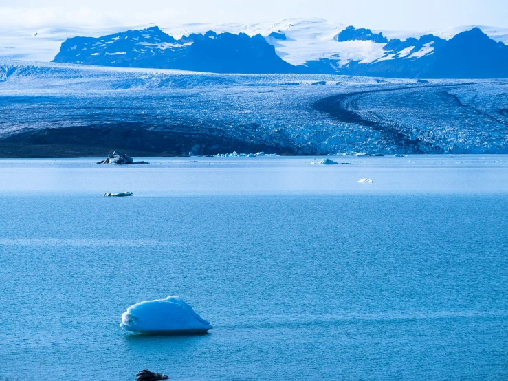 an iceberg sitting in a body of water