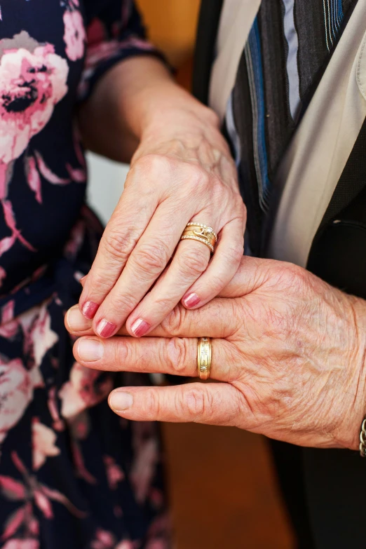 the married couple are holding hands holding each other