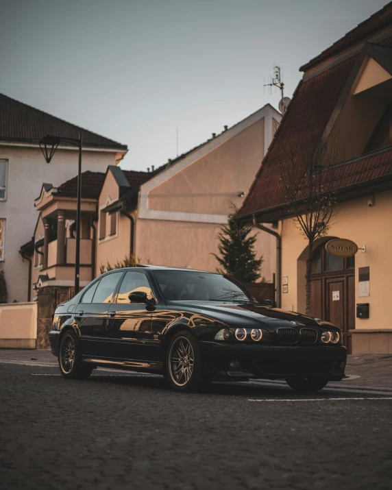 a black car parked in front of a house