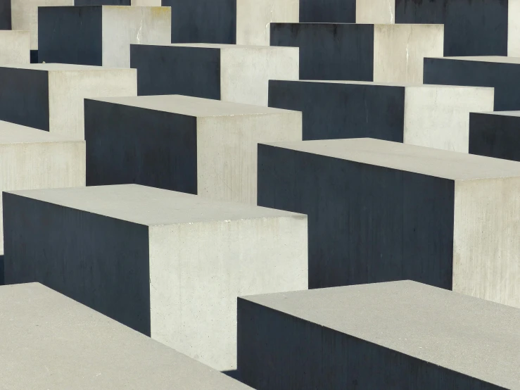 several black and white squares on concrete with a yellow sign