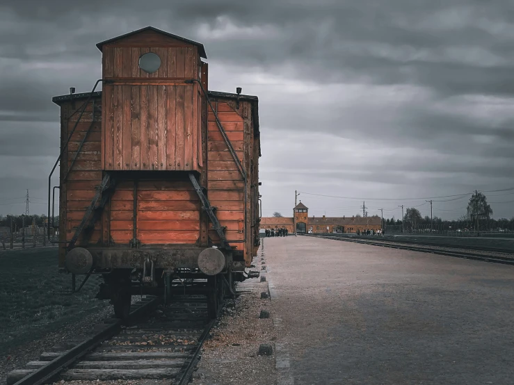 an old fashioned train cart sitting on the tracks