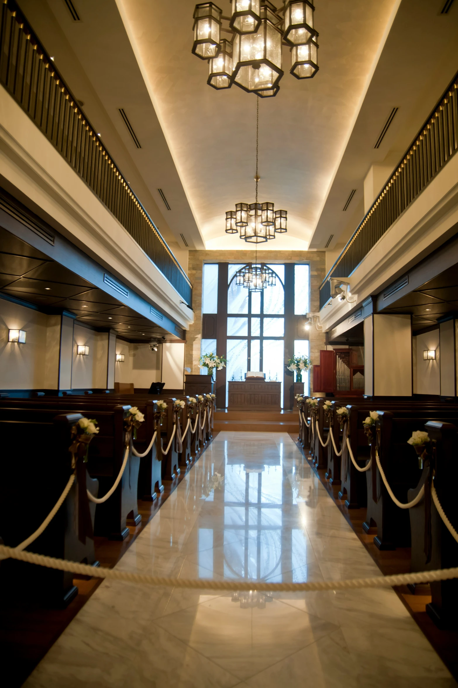 a long and narrow hallway with lights and decorations