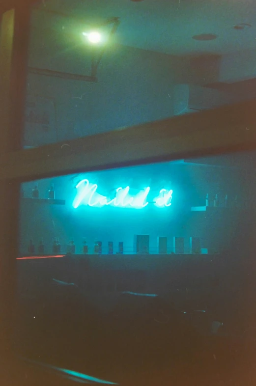 a blue lit sign in front of a window