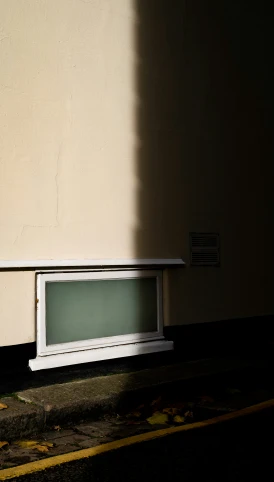 a white window sitting next to a wall in a room