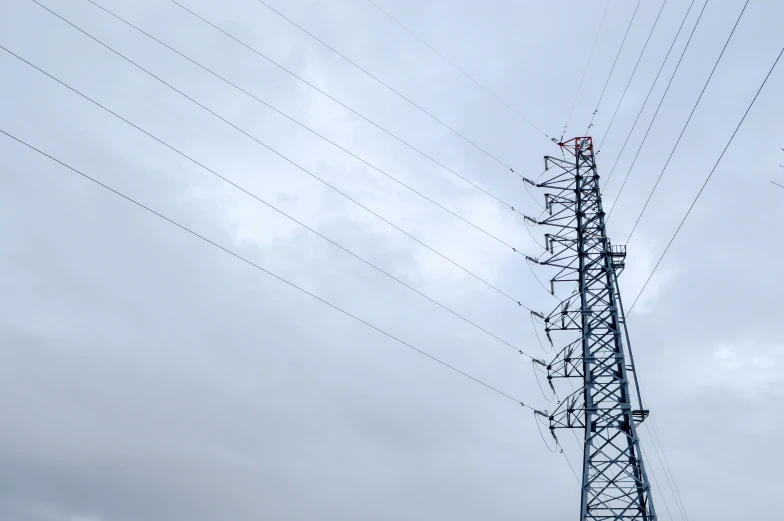 a high voltage tower sitting in the middle of a field