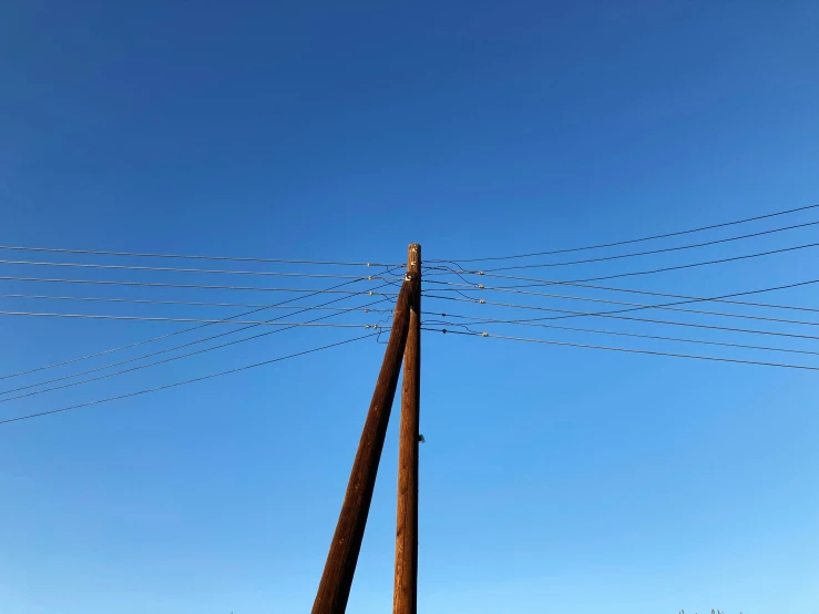 electrical lines against the blue sky in the sunshine