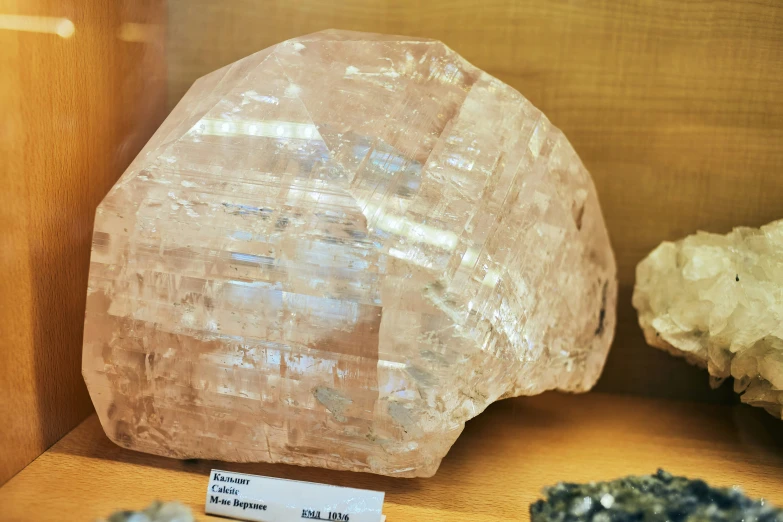 some very pretty crystals on a wooden display shelf