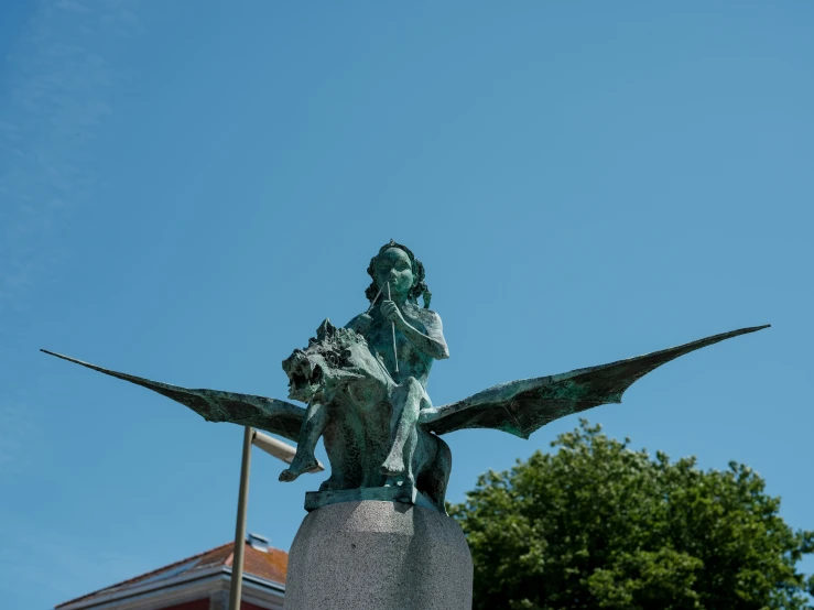 a bronze statue of a man with a bird on his arm