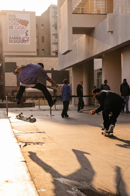 young men on skateboards doing tricks outside of a building