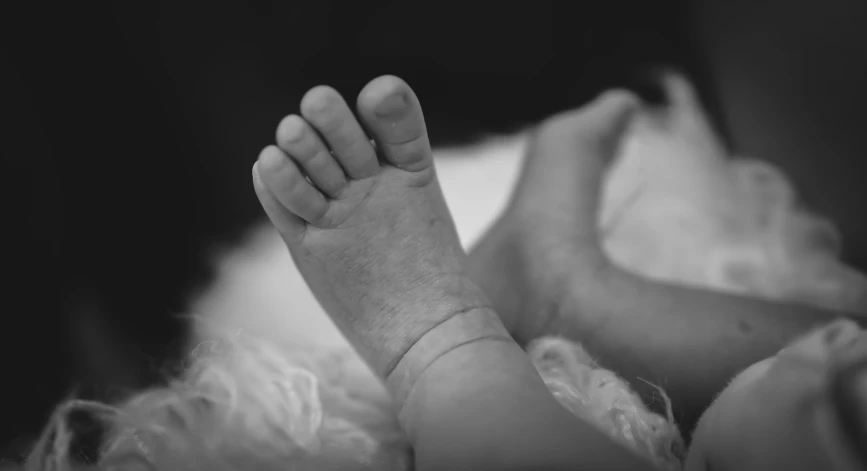 a black and white po of a baby's foot