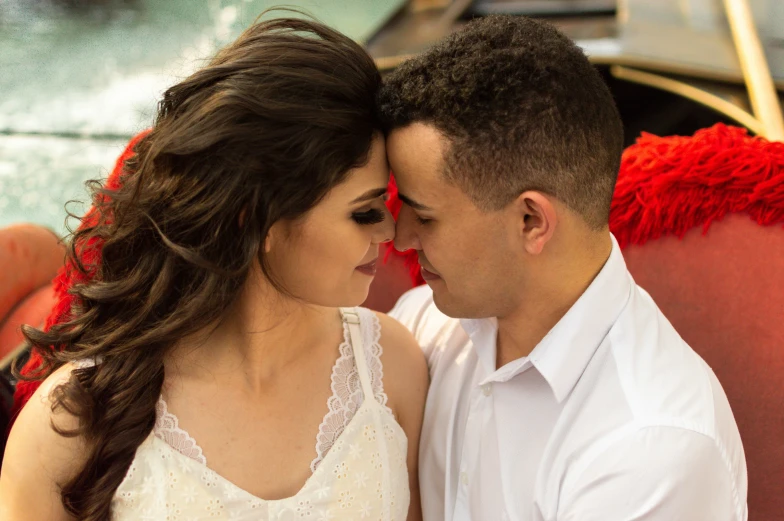 a beautiful young woman sitting next to a man on a boat