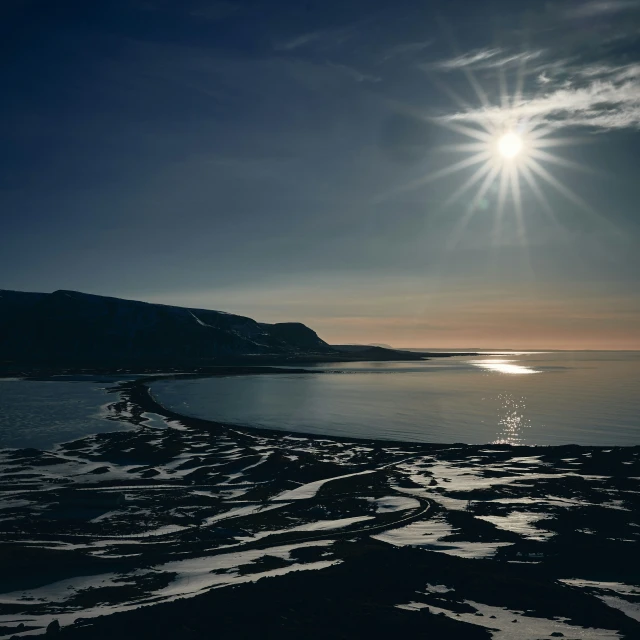 a beach and a large body of water at sunset