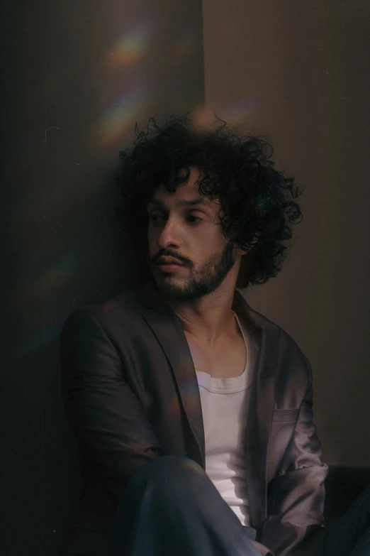 a man sitting in the corner of a room