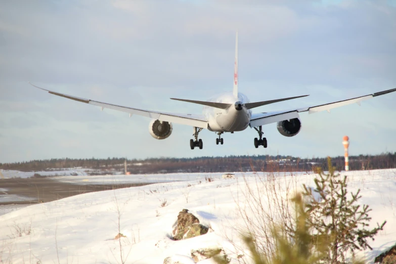 the plane is landing and landing on the snow