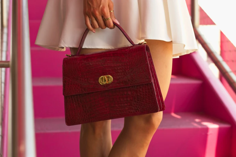 a lady carrying a red purse with a bright pink staircase