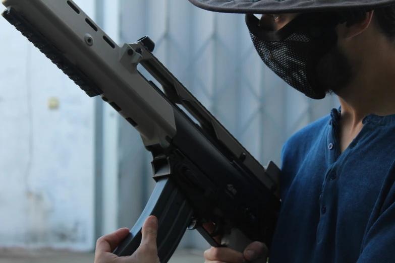 a man with a mask holding a rifle