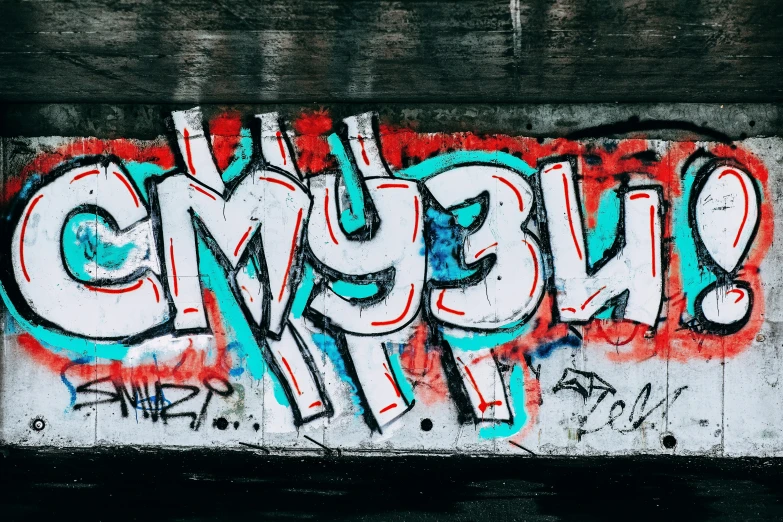 a wall has been sprayed with graffiti and some type of words