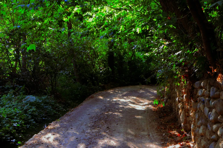 a stone wall along the side of the road