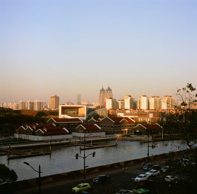 a city that is near the water with a very large city in the background