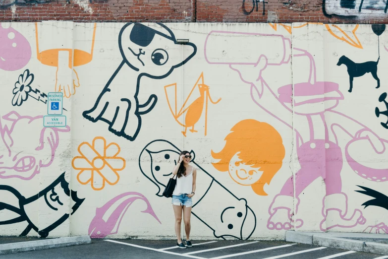 there is a woman standing next to a large wall