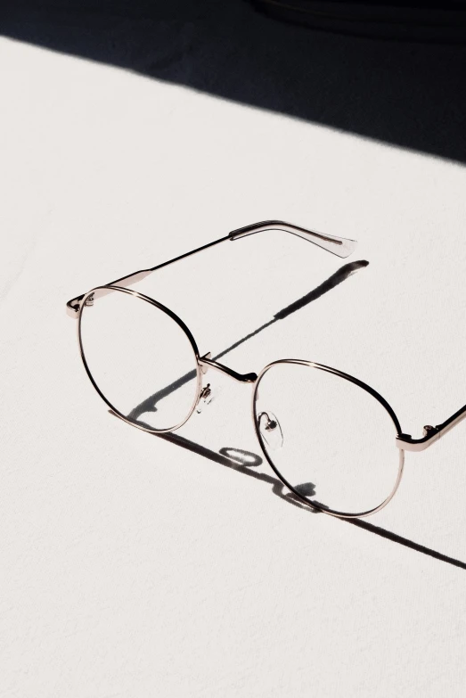 a pair of glasses laying on top of a table