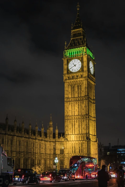 big ben and london bus lit up with lights in the evening