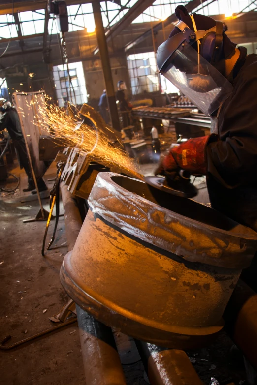 a man welding soing in an industrial area