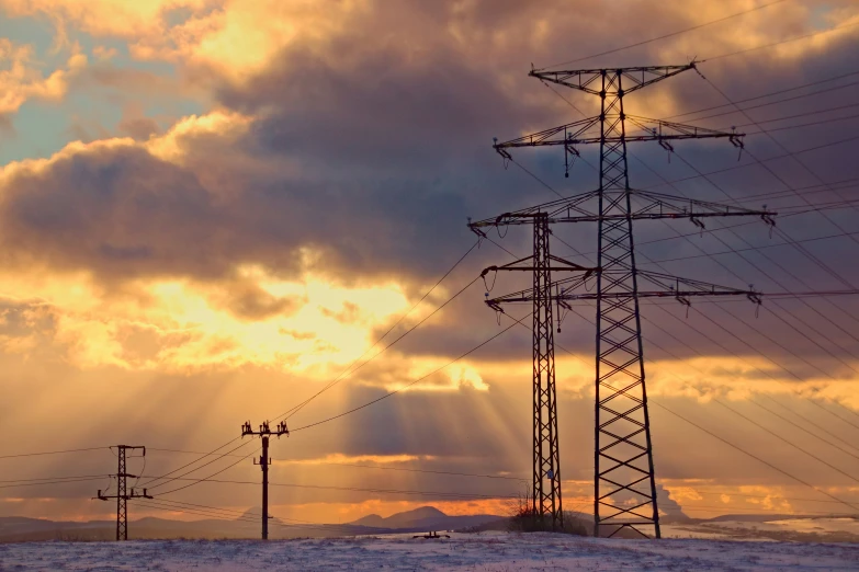 the sun is shining down on power lines