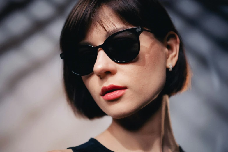 a close up of a woman in sunglasses wearing a necklace