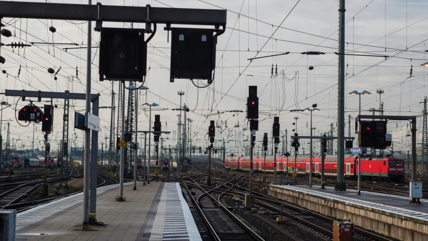 railroad tracks and train traffic lights on an overcast day