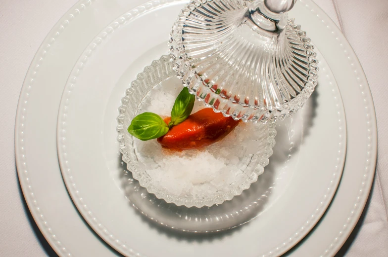 a small vase sitting on top of an elegant plate