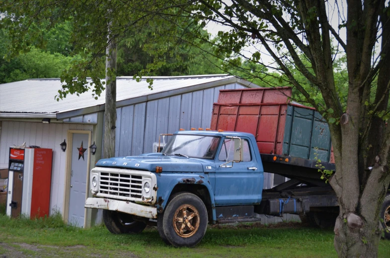 the truck is parked beside a shed