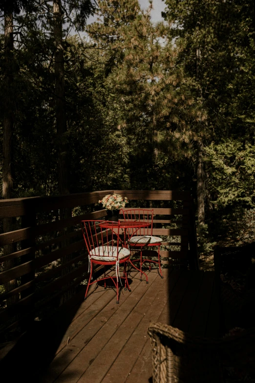 a patio with three chairs and two tables on it