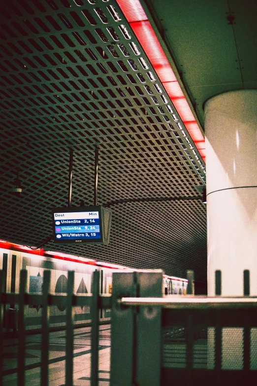 a train traveling through a train station next to a tall building