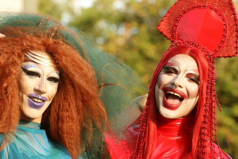 two people with makeup make up on and red hair